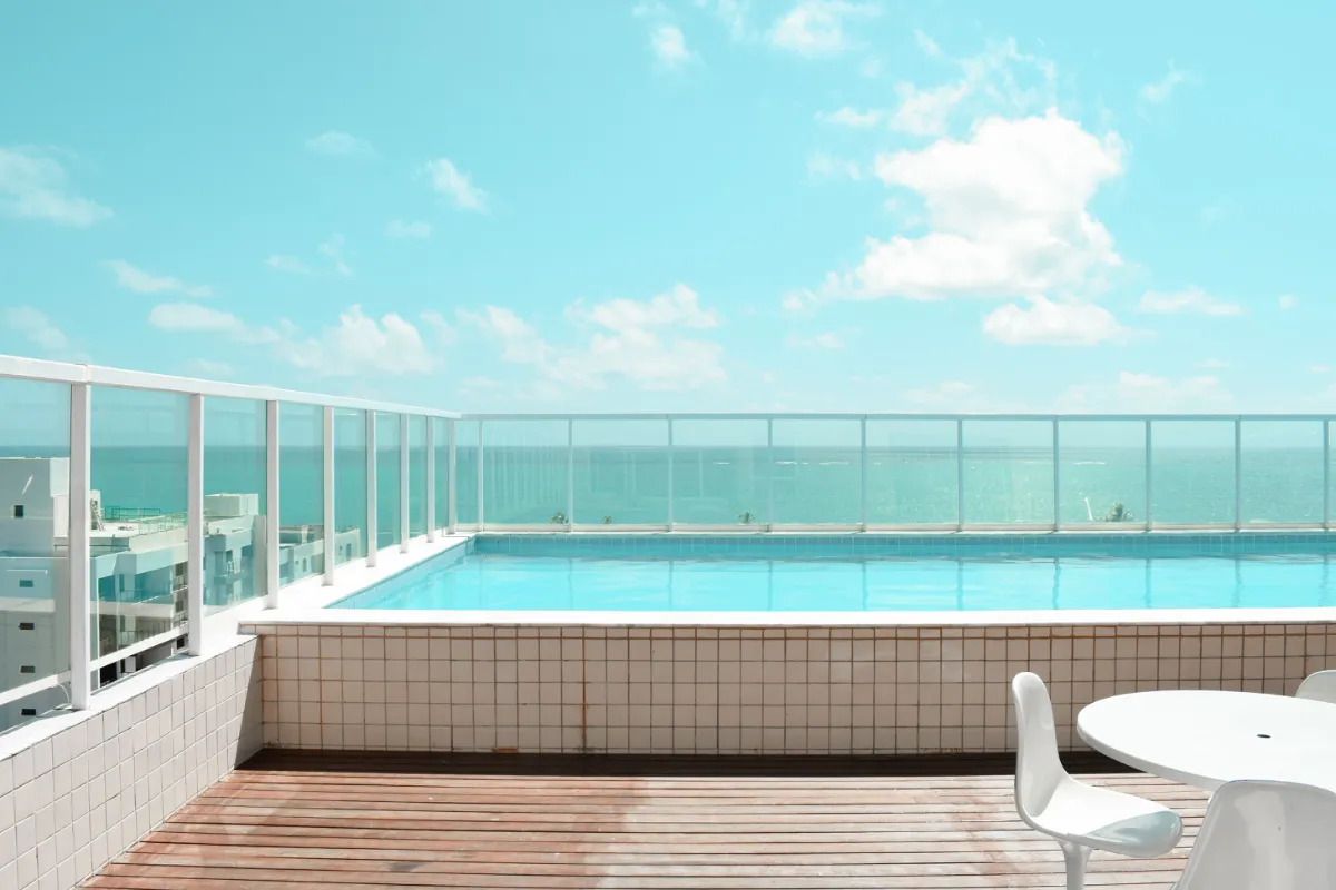 Rooftop apartment pool with glass pool fence overlooking the ocean